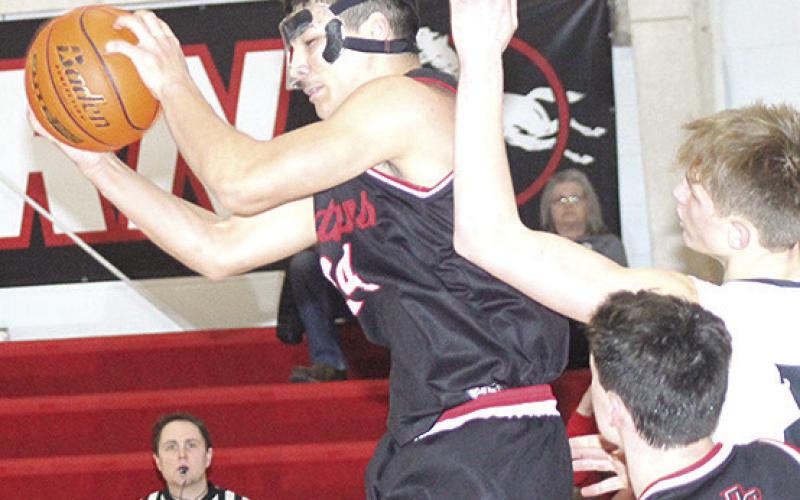 P.C.’s Atreyu Kling (#24, center) pulls in a tough rebound against E-M-F on Saturday. Paula Jasa/Republican