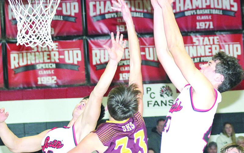 P.C.’s Oscar Machini (#40, right) and Anthony Kling (#23, left) go up for a rebound against Sterling in Friday night’s 59-29 victory over the Jets. Paula Jasa/Republican