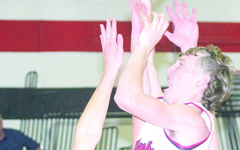 P.C.’s Justin Pierce (#5, center) puts up a shot over several Sterling defenders in Friday night’s game. Paula Jasa/Republican