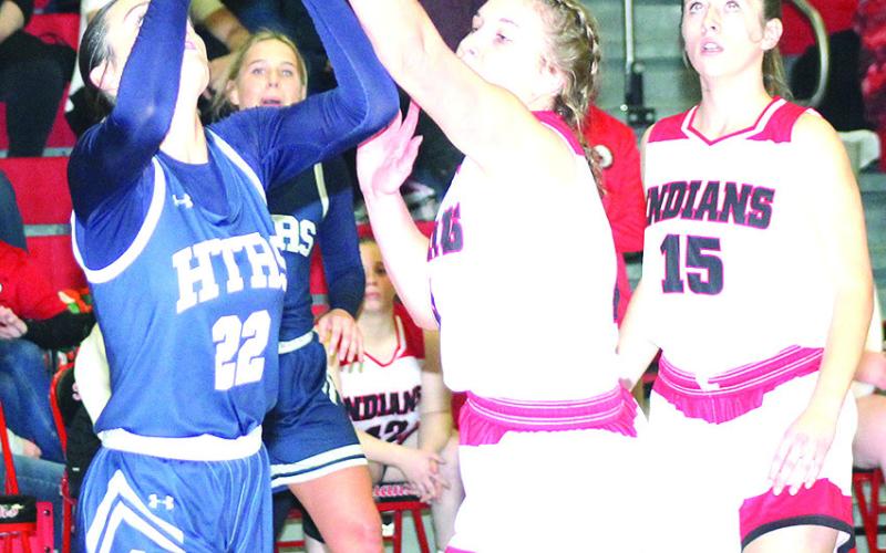 HTRS’ Lillian Bowen (left) tries a baseline shot against Pawnee City’s Cameron Ottersberg as teammate Hallye Friedly (#15, right) looks on. Paula Jasa/Republican