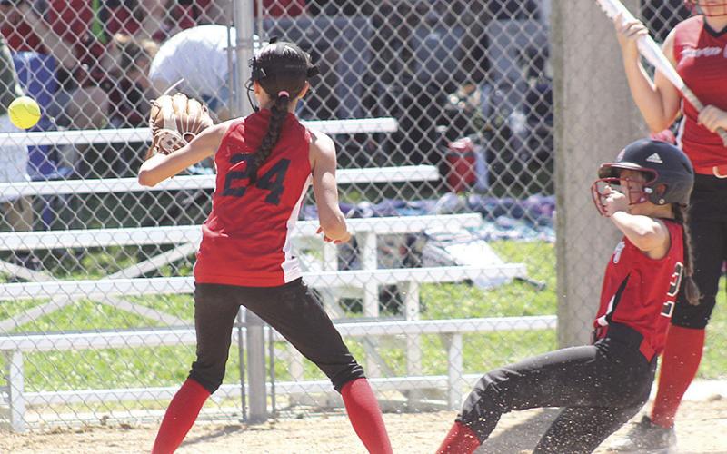 P.C.’s Mercy McLaughlin (#22, right) slides in safely at home plate to make it 8-2 in the bottom of the 3rd while teammate Lilah Yunghans (far right) looks on. Paula Jasa/Republican