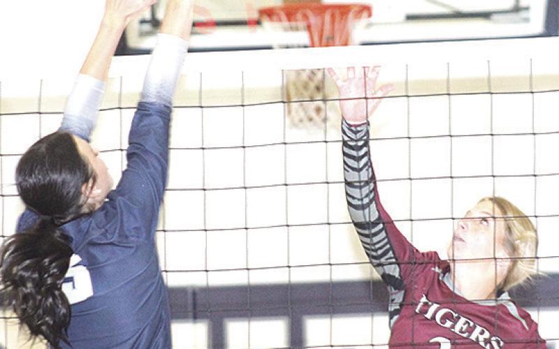 HTRS’ Lillian Bowen (#5, left) gets her hand on a block against LHS’ Justice Currie (#2, right). Paula Jasa/Republican