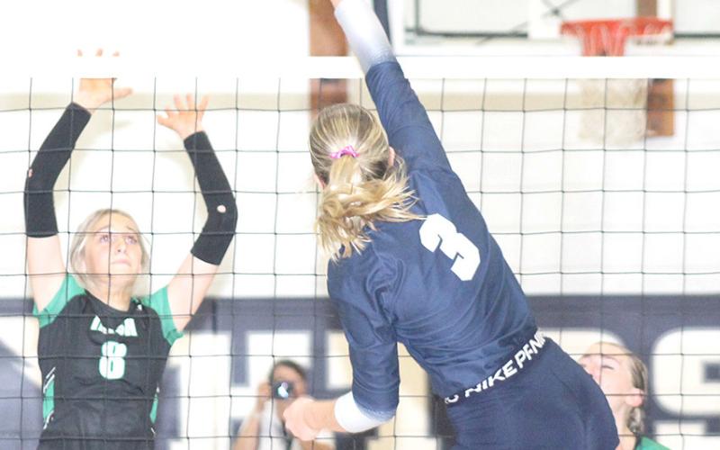 HTRS’ Macy Vrtiska (#3, center) drives a spike past several unsuspecting FCSH players in Tuesday night’s subdistrict final. Vrtiska had 6 kills in the match. Paula Jasa/Republican