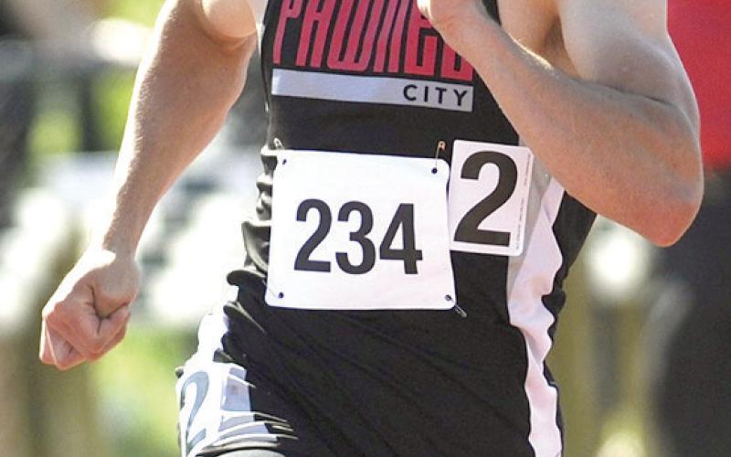 P.C.’s Jett Farwell rounds the corner of the Class D boys’ 400 M. Dash. He placed 6th with a time of 51.95. Photo by Luke Nichols/Beatrice Daily Sun