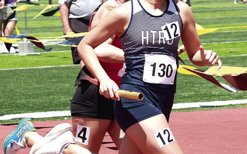 HTRS’ Laramie Glathar stays one step ahead of the competition in the Class D girls’ 3200 M. Relay. Photo courtesy of Lorrie Novak