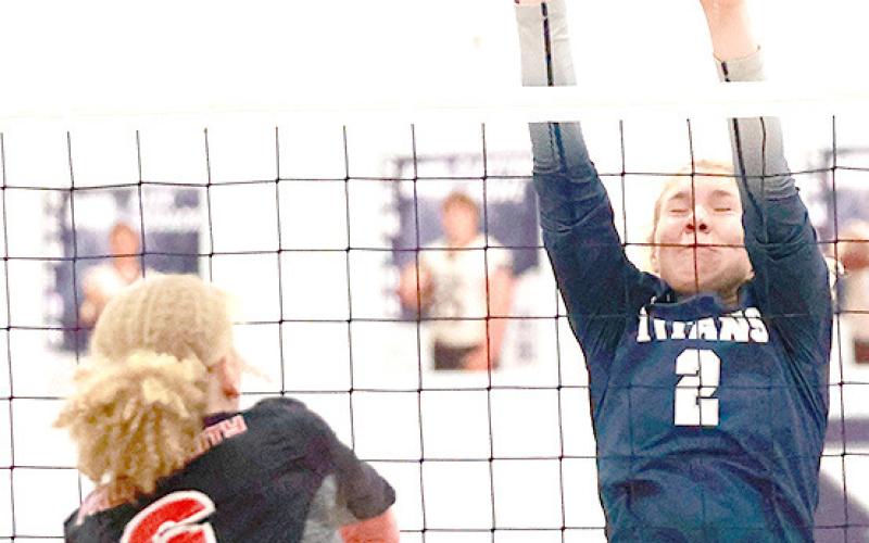 P.C.’s Madelyn Osborne (#6) tries to get a spike past HTRS’ Elie Bstandig (#2, right). Photo courtesy of Lorrie Novak