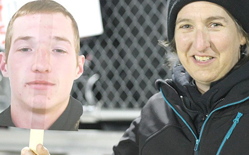 Pawnee City football mom Julie Pierce (right) shows off her son’s photo (Justin Pierce) before the game.
