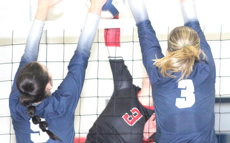 HTRS’ Lillian Bowen (#5, left) and Macy Vrtiska (#3, right) go up for an ace block against Meridian in Thursday night’s match. HTRS won in four sets. Paula Jasa/Republican