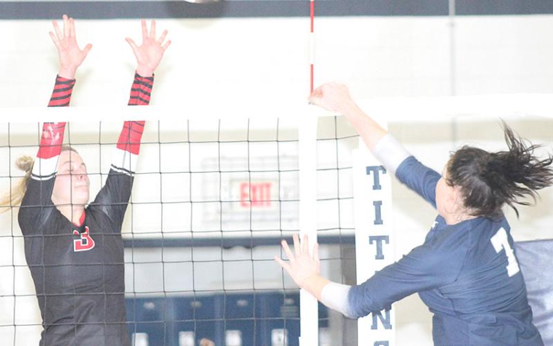 HTRS’ Hannah Koziol (#7, right) powers a spike past a Meridian blocker on Thursday night. Koziol had 5 kills and 34 digs in the match. Paula Jasa/Republican