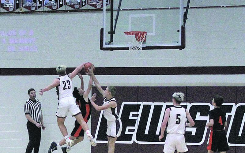 Lewiston Sophomore Brock Janssen leaps to block a score by a Dorchester Longhorn