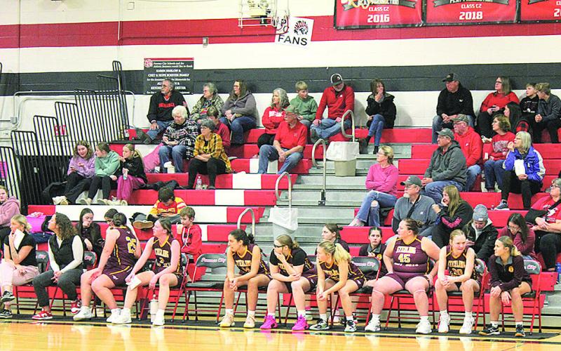 The Sterling Jets Girls Basketball Team, which includes Lewiston students, watches the game unfold from the sidelines