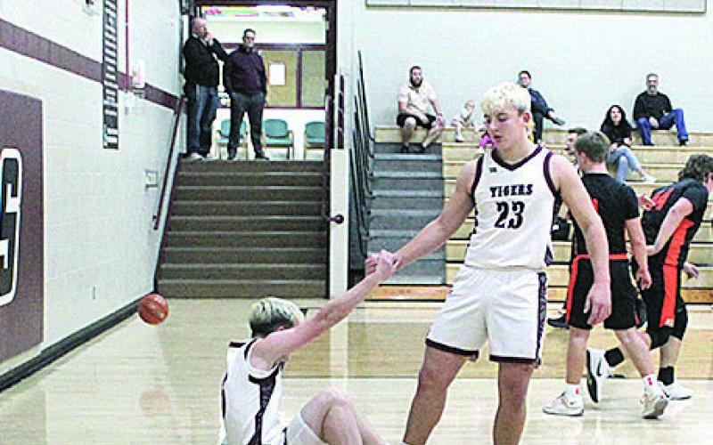 Lewiston Sophomore Brock Janssen helps his teammate to his feet