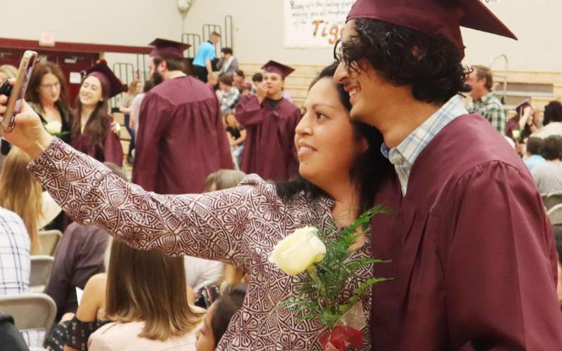 Lewiston Senior Abel Gonzalez shares a moment with his mom, Santa, at the Lewiston Graduation Sunday. Ray Kappel/Republican