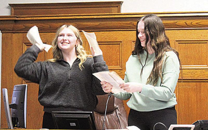 Adilyn Nincehelser (left) and Lexus Tichy (right) tear up Judge Gaertig’s books in their dramatization of “criminal mischief”
