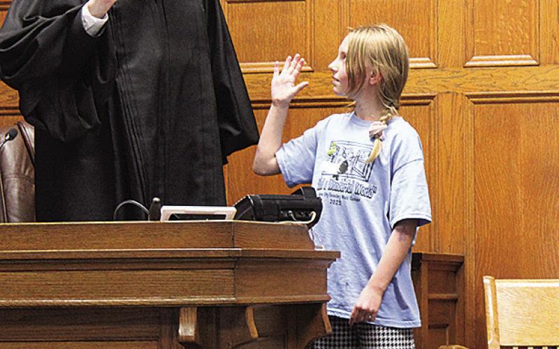 Pawnee City fifth grader Chloe is sworn in as a witness by Judge Gaertig