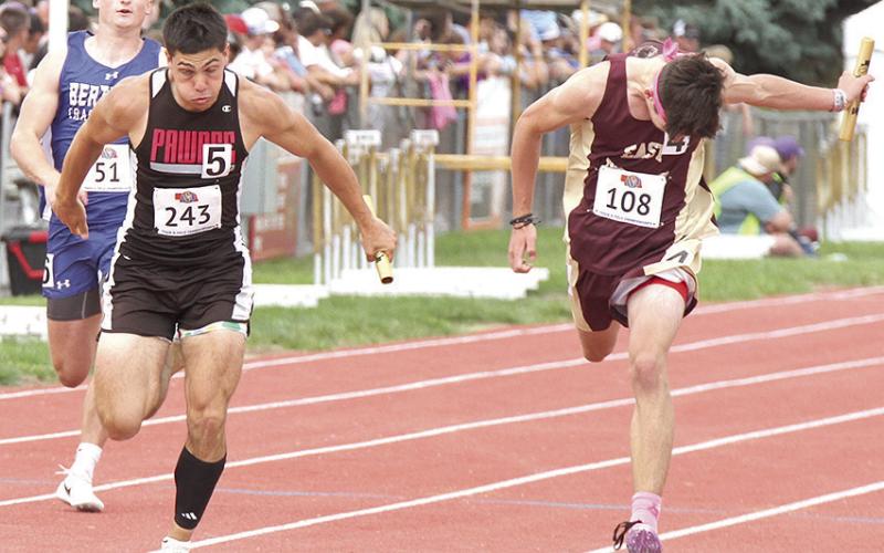 Pawnee City’s Anthony Kling (center, #243) crosses the finish line just ahead of two other runners in the Class D boys’ 400 M. relay. P.C. finished 7th with a time of 44.65. Photo courtesy of Stephanie Croston/Seward County Independent