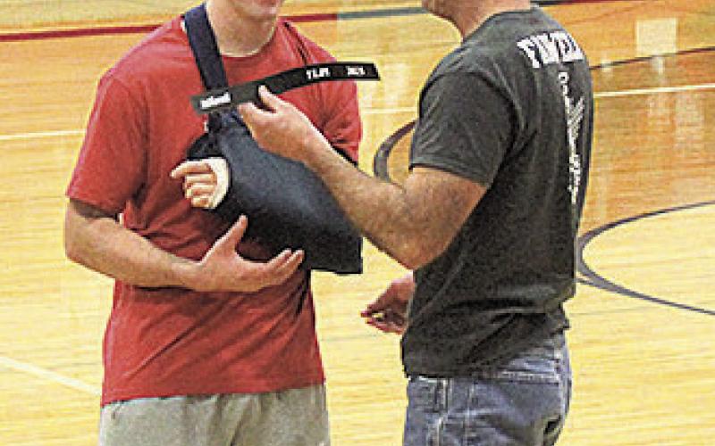 Jett Farwell (left) was recognized for breaking his dad, Mike Farwell's previous 100 m record