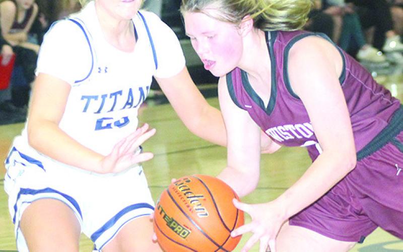 LHS’ Ayden Hunzeker (right) drives against HTRS’ Jaylie McNealy (#23, left) in Tuesday night’s game. Paula Jasa/Republican