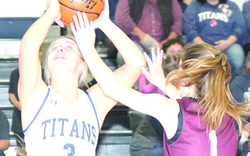 HTRS’ Laramie Glathar (#3, left) goes up for a shot underneath as LHS’ Kierstin Rehrs (#1, right) defends. Paula Jasa/Republican
