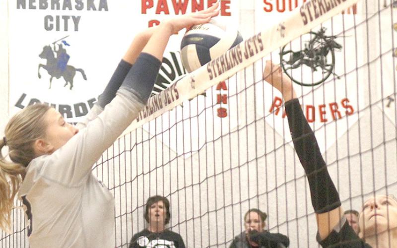 HTRS’ Macy Vrtiska (#3, left) stuffs an E-M-F player trying to tip the ball over the net. Vrtiska had two solo ace blocks against the Bobcats and 6 kills. Paula Jasa/Republican