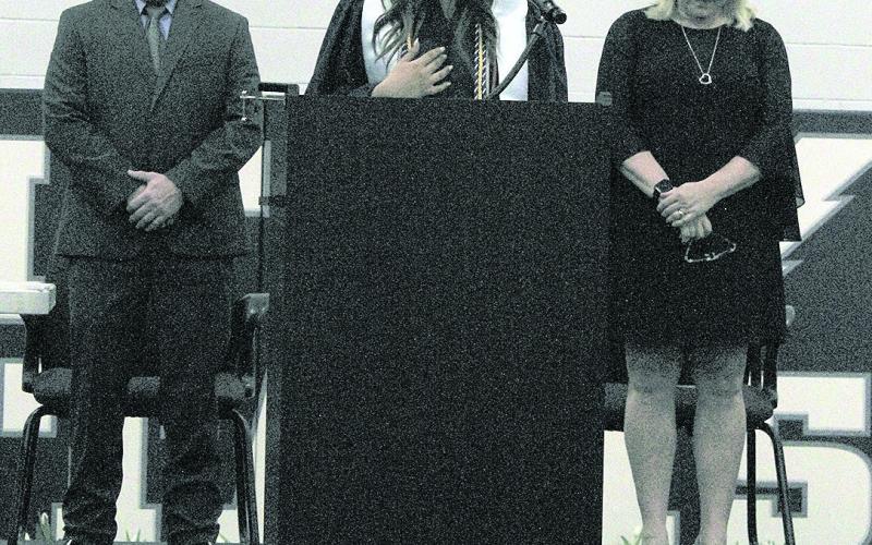 Top left: HTRS graduates from left to right: Jorja Dejonge, Shayfer Cumro, Zachary Burns, Elizabeth Bstandig, Madison Bredemeier, Kirk Bass Top right: Flanked by Kyle Hilgenfeld (left) and Kim Caniglia (right), Shayfer Cumro (center) delivers the invocation. Bottom left: Emmet Glathar gives a tulip to a family member during the Presentation to Families Bottom right: Jon Koch (left) and Lillian Bowen (right) deliver the class address.