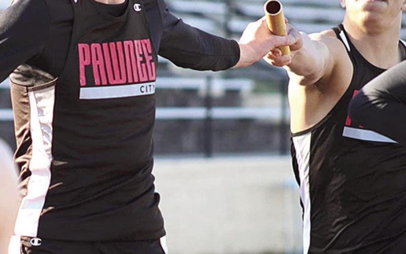 P.C.’s Drew Menninga (left) takes the baton from teammate Trey Kling (right) in the boys’ 1600 M. relay. Photo courtesy of Jamie Maloley