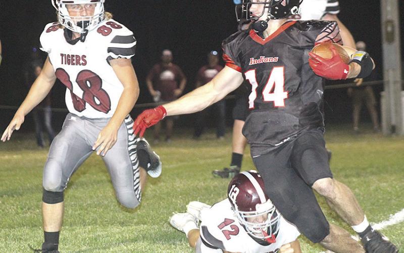 P.C.’s Jett Farwell (#14, right) eludes several Lewiston tacklers including Ashton Sanders (#12, below) and Zander Wagner (#88, left) on his way for a touchdown. Farwell scored 5 touchdowns in the game and had 244 yards of rushing. Paula Jasa/Republican