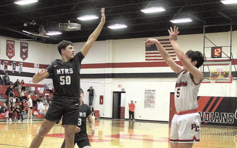 HTRS Titan Cole Hunzeker jumps to block Pawnee City Indian Jordan Wernimont’s shot