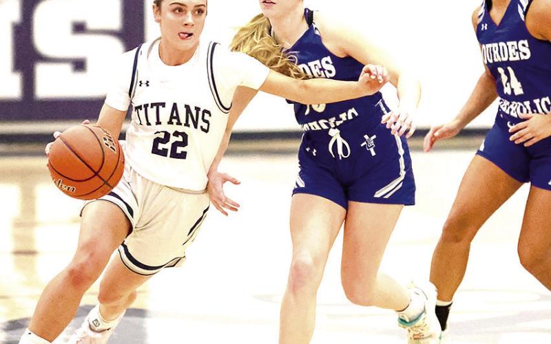 HTRS’ Lillian Bowen (#22, left) drives past two NCL Lady Knight defenders on her way down the floor. Bowen scored 13 points for HTRS in their close 49-54 loss. Photo courtesy of Lorrie Novak