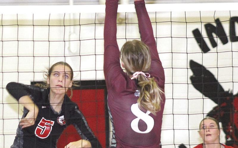 P.C.’s. Emalyse Gottula (#5, left) powers a spike against LHS’ Maddie Janssen (#8, center) while teammate Cameron Ottersberg (#1, right) looks on. Paula Jasa/Republican