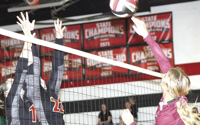 LHS’ Justice Currie (right) tries to slip a shot past Pawnee City’s Logan Maloley (#11, left) and Adelyn Sisco (#22) in last Tuesday night’s game. Paula Jasa/Republican