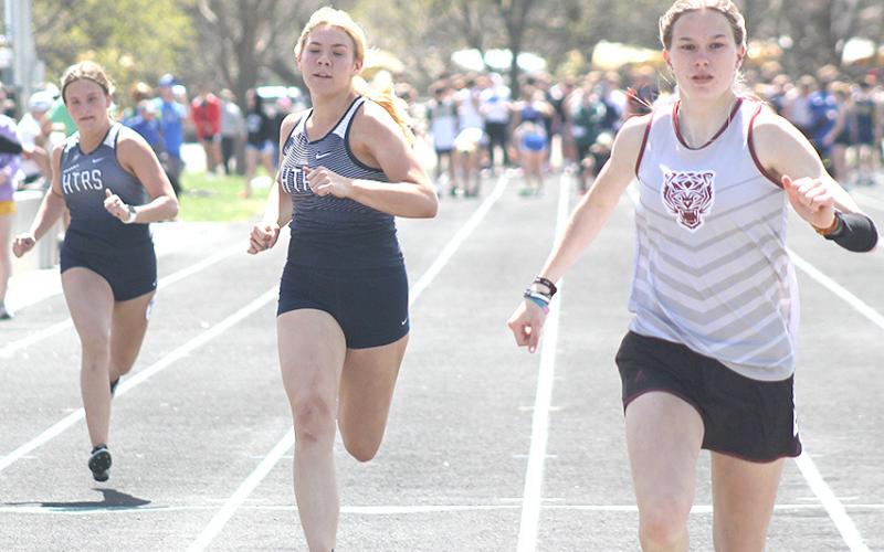 Lewiston’s Katelyn Sanders (right) finishes ahead of HTRS’ Elie Bstandig (center) and Shayfer Cumro (left) in the prelims of the girls’ 100 M. Dash. Paula Jasa/Republican