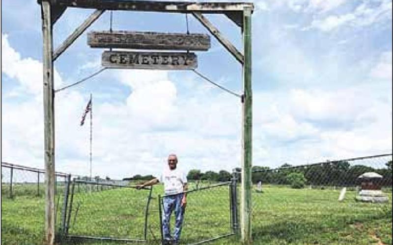 Shad Gager at the Clear Creek Cemetery entrance Sharla Sitzman Photo