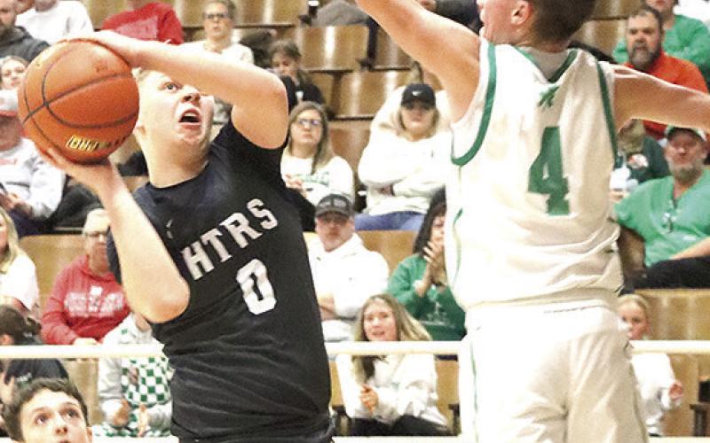 HTRS’ Jonathan Koch (#0, center) goes up for a nice shot on the baseline against FCSH in the Class B boys’ Championship game on Saturday. Paula Jasa/Republican