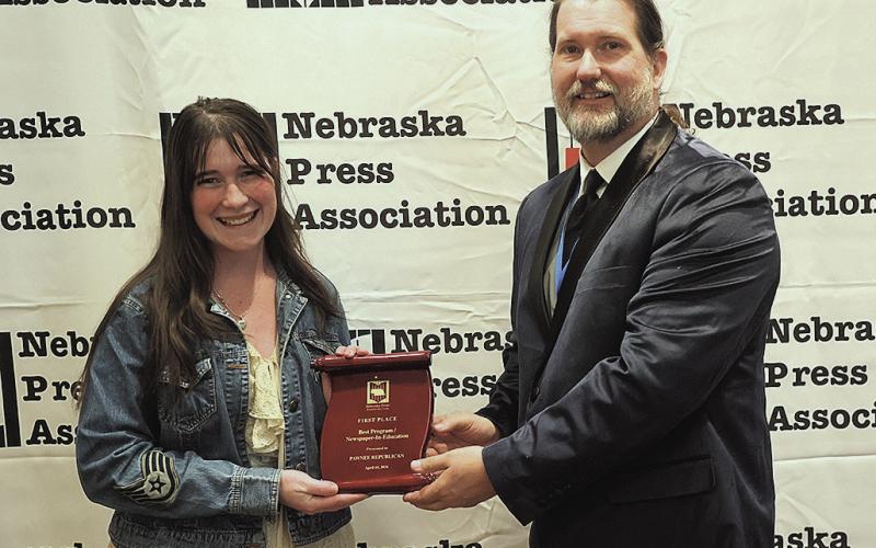 Reagan Connelly (left) receives the first place plaque from Timothy Linscott (right) on behalf of The Pawnee Republican Photo courtesy of Jeremy Buss