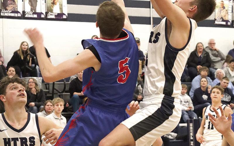 HTRS’ Brennen Vaughan (center) gets fouled on an offensive rebound and putback try at the end of the game as teammates Hunter Bohling (#22, left) and Emmett Glathar (#11, right) look on. HTRS lost a close one to Palmyra 46-53 last Thursday night. Paula Jasa/Republican
