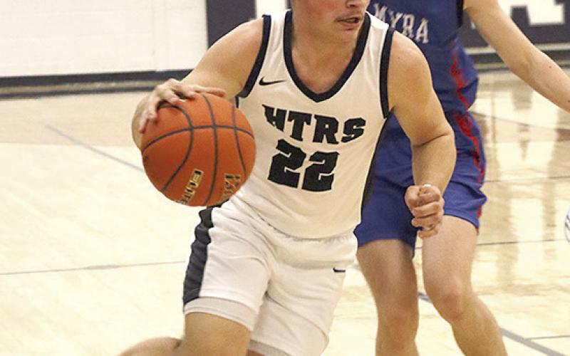HTRS’ Hunter Bohling (#22) drives past a Palmyra player in the Titans’ final regular season game. Paula Jasa/Republican
