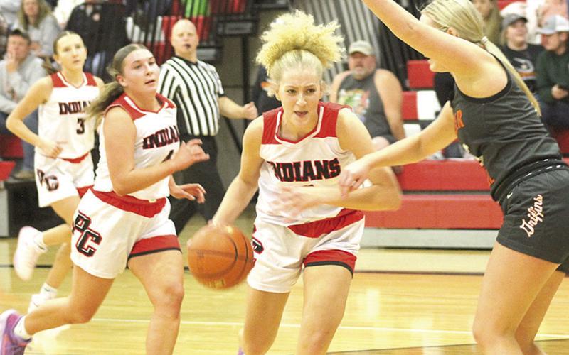 P.C.’s Maddy Osborne (center) drives the paint against Diller/Odell on Thursday night as teammates Kinsley Benson (#3) and Cameron Ottersberg (#4) look on. Paula Jasa/Republican