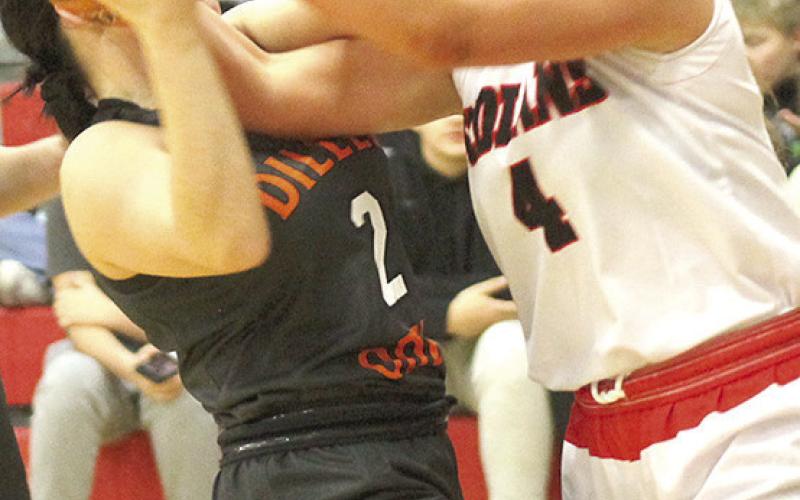 P.C.’s Cameron Ottersberg (#4, right) battles a Diller/ Odell Lady Griffin for possession under the bucket. Paula Jasa/Republican