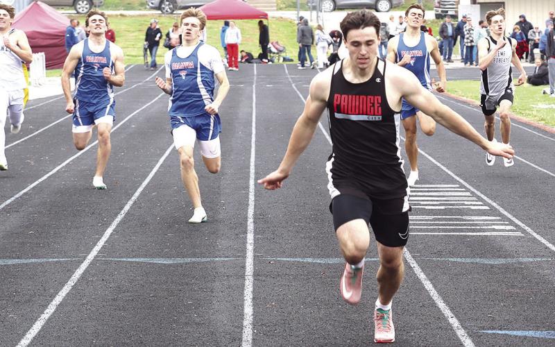 Pawnee City’s Jett Farwell (center) blasted the field in the boys’ 400 M. Dash for a record-setting time of 50.37. Also pictured is Drew Menninga (far right) who finished 7th clocked at 53.90. Paula Jasa/Republican