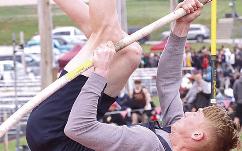 HTRS’ Brogan Dunlap bends the pole for extra leverage in the Pole Vault event as a competitor looks on. Paula Jasa/Republican