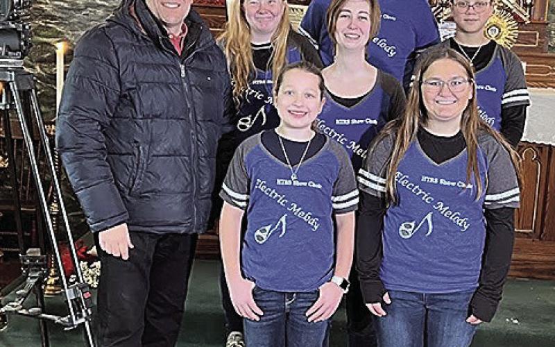 Jon Vanderford, left, of Pure Nebraska with the HTRS Show Choir in the Museum at Old St. John’s Catholic Church in Table Rock. Back row: Jake Manning. Middle Row: Alyssa Askren, teacher Katie Umland, and Brittyn Monarrez. Front row: Ellisyn Herr and Kendal Freeman.