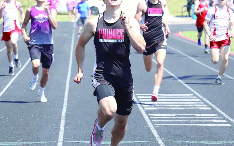 Pawnee City’s Jett Farwell (center) finishes hard in the Class D-1 boys’ 400 M. Dash while teammate Drew Menninga (right) finishes 2nd to qualify for State. Jasa/Republican