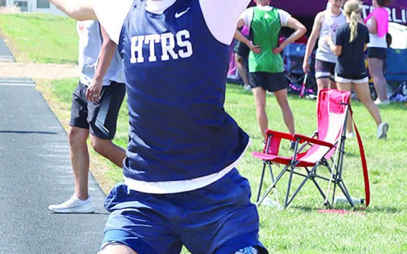 HTRS’ Kiffen Hunzeker (above) soars in the boys’ Long Jump event while LHS’ Justice Currie (right) gets some extra distance in the Triple Jump. Hunzeker placed 2nd in the Long Jump at 18’11 1/2” to qualify for the State Track Meet. Jasa/Republican