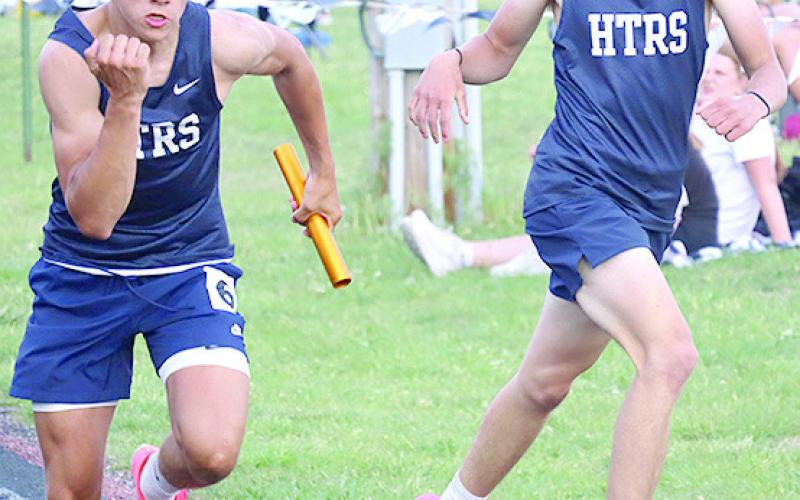 HTRS’ Kameon Dettmann (left) takes the handoff from Axton Wamsley in the boys’ 1600 M. relay. Kameon qualified for State in the 800 M. run. Jasa/Republican