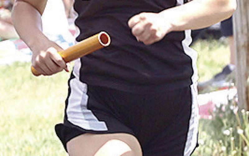 P.C.’s Logan Maloley carries her leg of the girls’ 3200 M. Relay.