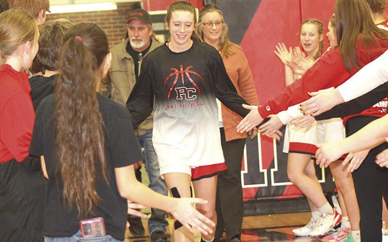 Paula Jasa/Republican P.C.’s Hallye Friedly runs through the tunnel of sportsmanship from all of the athletes who represented the Pawnee City Senior/Parent’s Night on Tuesday night in their game against Humboldt Table Rock Steinauer.