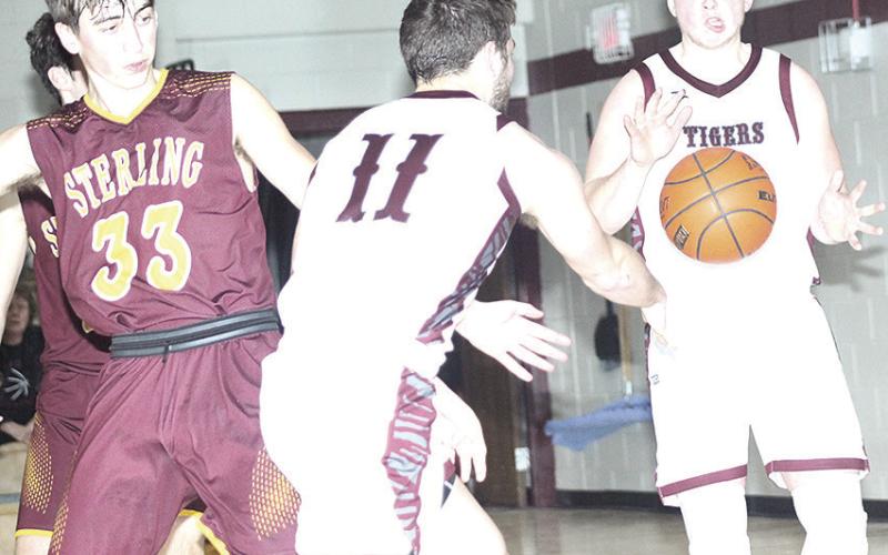 LHS’ Brady Bledsaw (#11, left) makes a perfect pass to teammate Caleb Rule (right for an easy bucket. Bledsaw led Lewiston with 24 points against Sterling. Paula Jasa/Republican