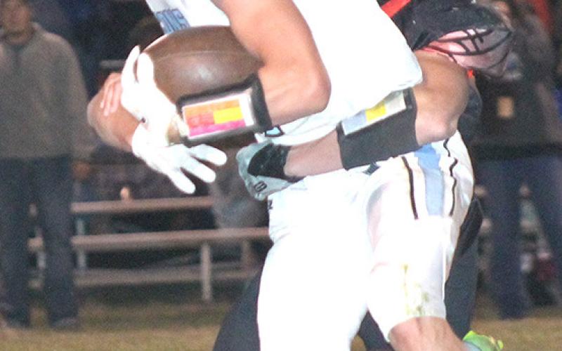 P.C.’s Trey Marteney drags down a Falcon ball-carrier in Friday night’s quarterfinal action. Paula Jasa/Republican