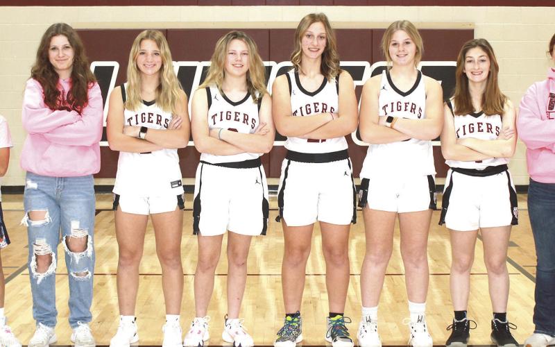 Members of the 2023-24 Lewiston Girls’ Basketball Team are from left: Braxten Eagleburger, s.m., Savannah Cutshall, s.m., Justice Currie, Ayden Hunzeker, Maddie Janssen, Delanye Currie, Kierstin Rehrs, Bryleigh Crouse, s.m. Not pictured: Sara Wiles, Head Coach Matt Sholty, Asst. Coach Kohlton Gabehart.